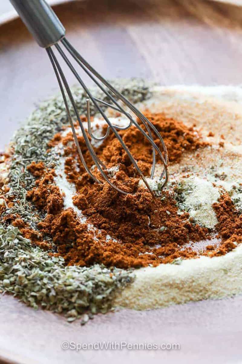 whisking spices together to make Cajun Seasoning