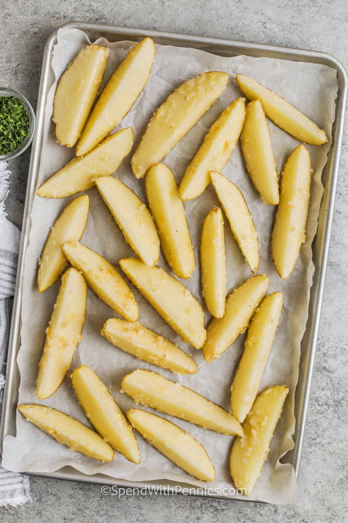 potato wedges on a sheet pan to make Crispy Baked Potato Wedges