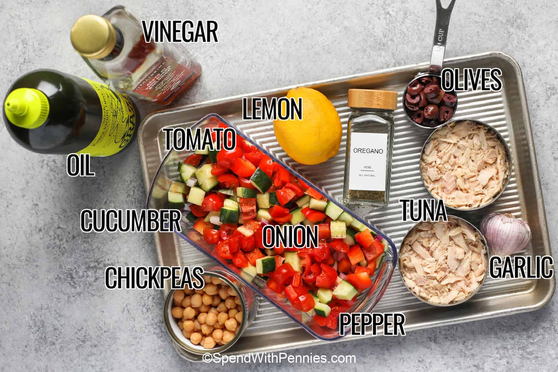 Prepare this Mediterranean tuna salad when you need a quick meal with no cooking and very little cleanup. Canned tuna, chickpeas, crisp vegetables, olives, and fresh parsley are gently folded into a tangy olive oil dressing with lemon, vinegar, oregano, and garlic. The result is fresh, savory, and easy to serve over greens, in pita, or inside a tortilla. Save this simple no-mayo tuna salad for later. #spendwithpennies oil , vinegar , tomato , cucumber , chickpeas , onion , pepper , lemon , oregano , tuna , garlic , olives with labels to make Mediterranean Tuna Salad