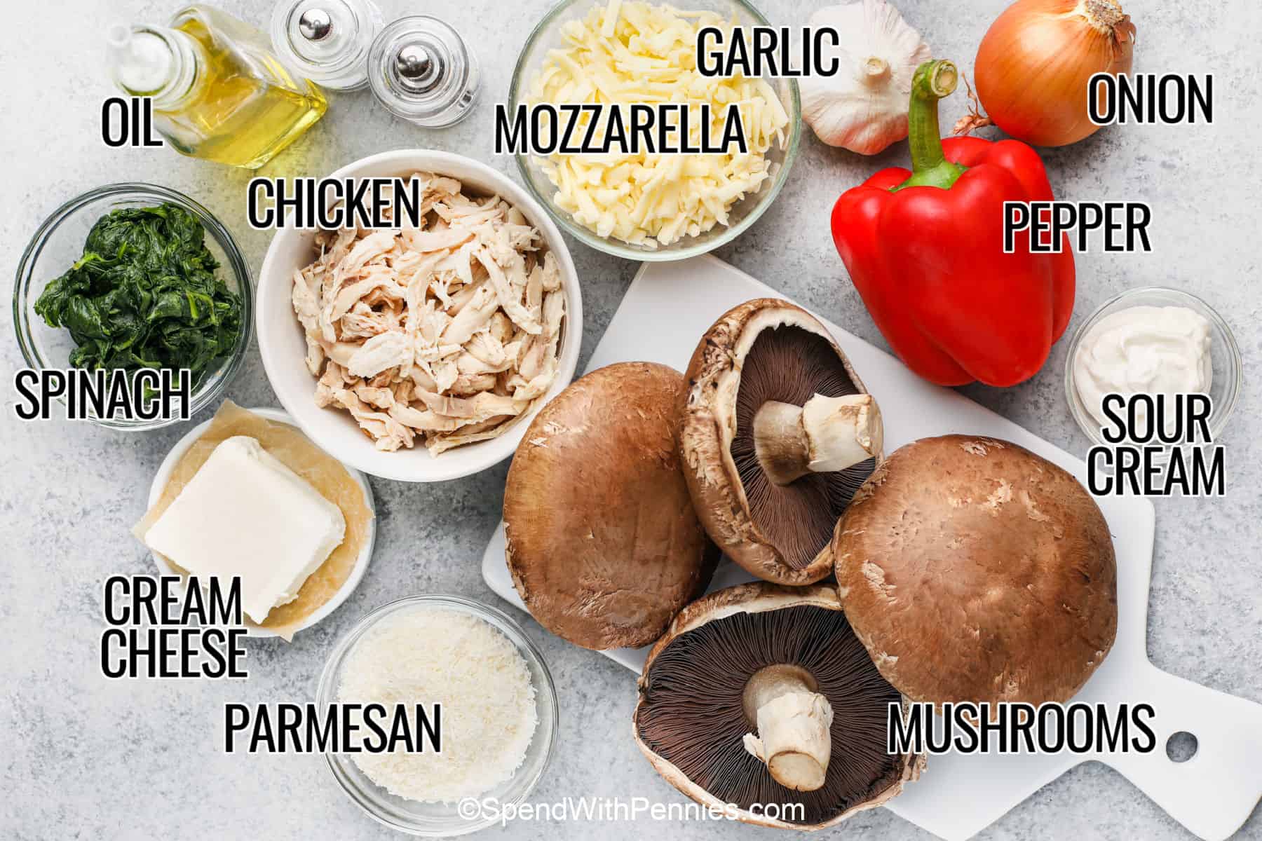 These stuffed portobello mushrooms are filled with a creamy mixture of chicken, spinach, cream cheese, mozzarella, and Parmesan before baking until golden and bubbly. Roasting the mushrooms first keeps the filling rich and flavorful, making this recipe perfect for an easy weeknight dinner or a cozy weekend meal. Save this recipe to make whenever you have leftover chicken. #spendwithpennies oil , chicken , spinach , cream cheese , parmesan , mozzarella , garlic , onion , pepper , sour cream , mushrooms with labels to make Stuffed Portobello Mushrooms