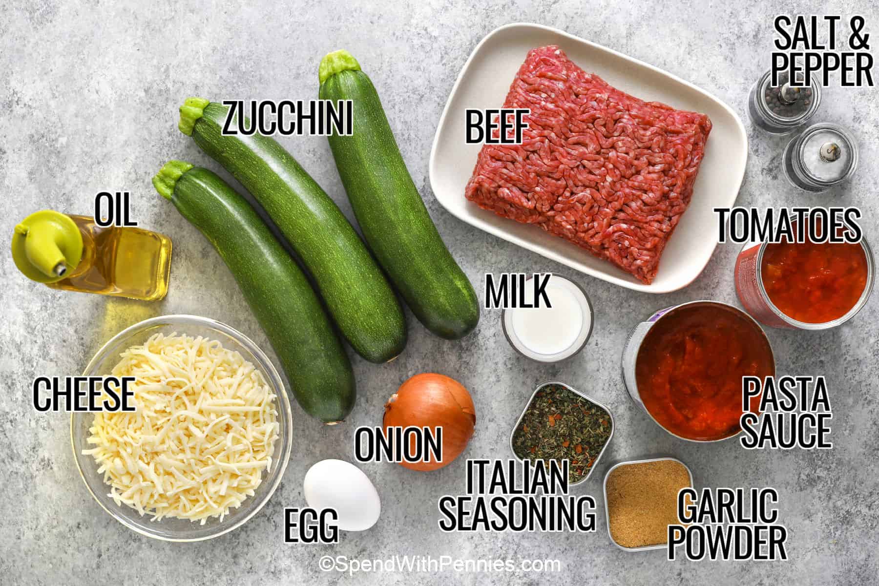 Zucchini hamburger casserole turns fresh zucchini into a hearty dinner with seasoned ground beef, thick pasta sauce, diced tomatoes, and a golden Italian cheese topping. Sautéing the zucchini first keeps it tender and helps reduce excess moisture as the casserole bakes. Serve this comforting meal on its own or over pasta, rice, or quinoa for extra servings. Save this recipe for an easy family dinner. #spendwithpennies labelled ingredients for zucchini hamburger casserole