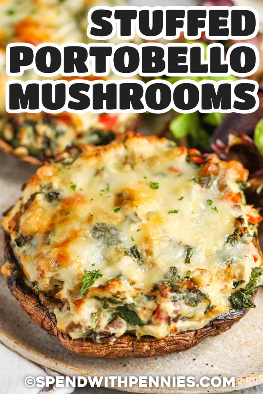 These creamy stuffed portobello mushrooms are filled with chicken, spinach, cream cheese, mozzarella, and Parmesan for a rich, savory dinner that everyone will love. The filling comes together quickly and bakes until perfectly bubbly. Whether you're cooking for family or guests, this recipe is always a favorite. Pin it to your dinner board. #spendwithpennies plated cheesy Stuffed Portobello Mushrooms with writing