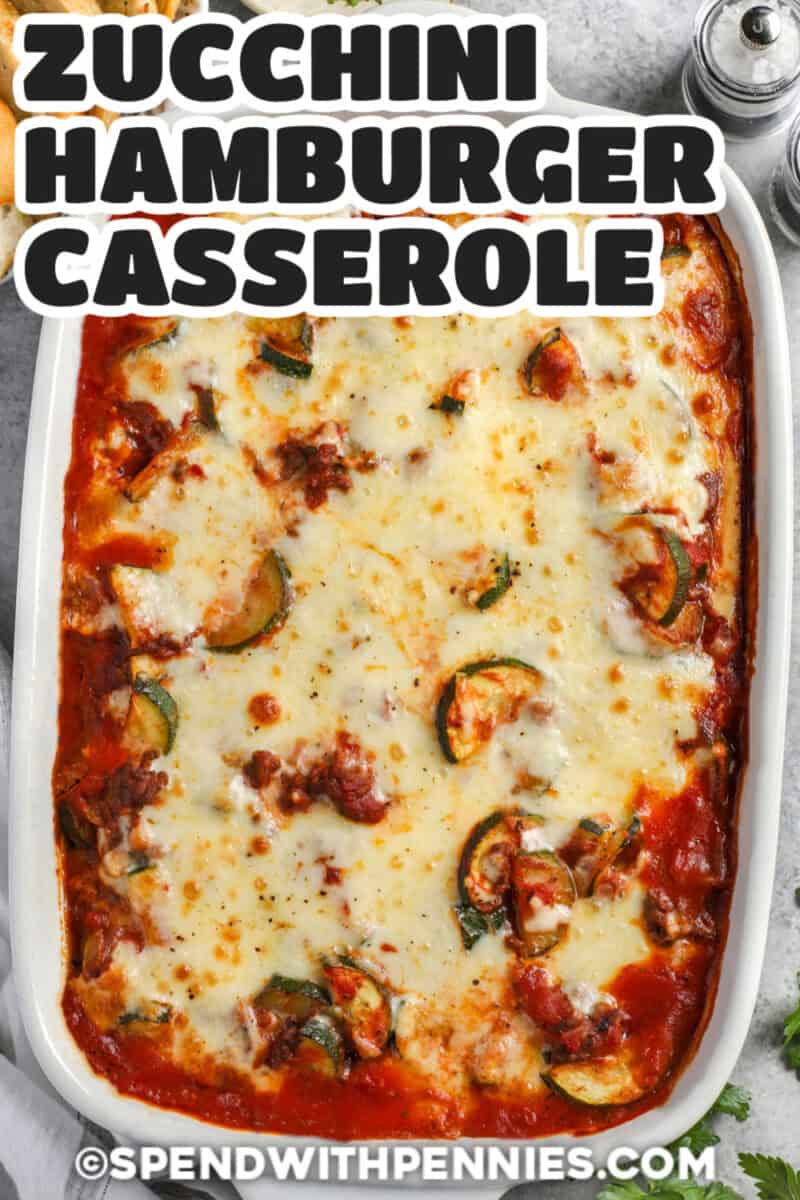 Cheesy zucchini hamburger casserole is a comforting way to use fresh zucchini without hiding its flavor or texture. Seasoned ground beef and onion are mixed with tomato sauce and diced tomatoes, then finished with a bubbly Italian cheese topping. The skillet-to-oven method keeps the process simple, and a short rest helps each portion hold together. Pin this recipe for an easy vegetable-packed family dinner. #spendwithpennies Zucchini Hamburger Casserole in a casserole dish
