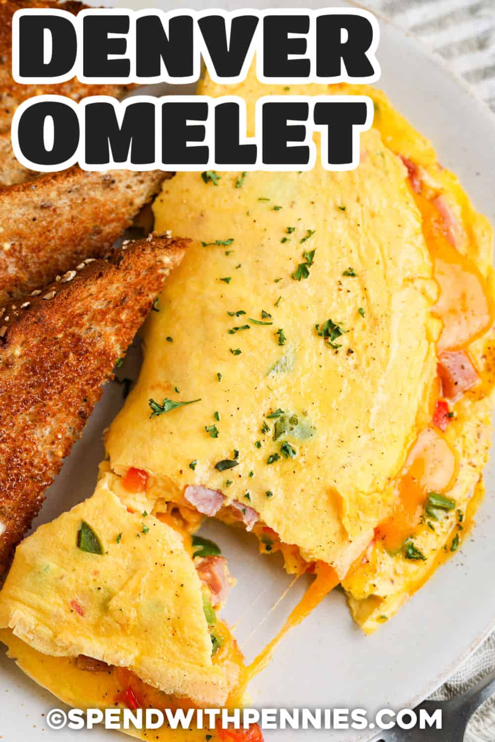 This Denver omelet is a practical way to turn leftover ham and a few everyday ingredients into a warm, filling breakfast. Tender peppers and onion add color and sweetness, while sharp cheddar brings rich, melty flavor to the fluffy eggs. The filling can be prepped in advance, making the final omelet especially quick to cook. Pin this omelette for weekend brunch, holiday leftovers, or an easy breakfast-for-dinner. #spendwithpennies cheesy Denver Omelet with toast and a title