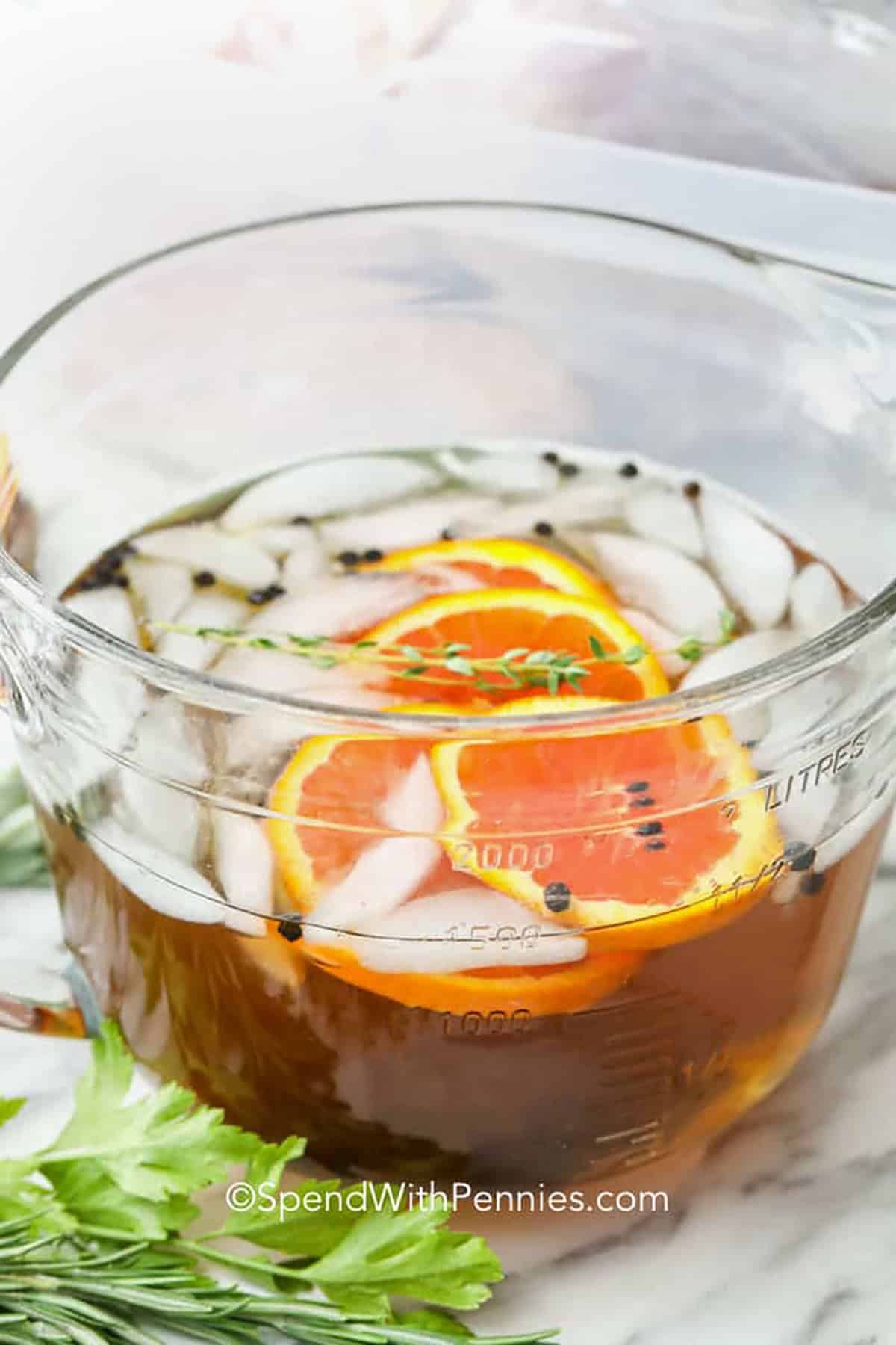 Try this turkey brine with apple cider for a sweet variation on the classic recipe. Apple cider, kosher salt, brown sugar, garlic, peppercorns, rosemary, thyme, and sage give the turkey a warm seasonal flavor before roasting. The hands-on preparation takes only a few minutes, and the chilled brine does the rest in the refrigerator. It is an easy way to prepare a juicy Thanksgiving turkey without complicated ingredients or constant basting. Save this recipe for your next meal. #spendwithpennies turkey brine in a bowl