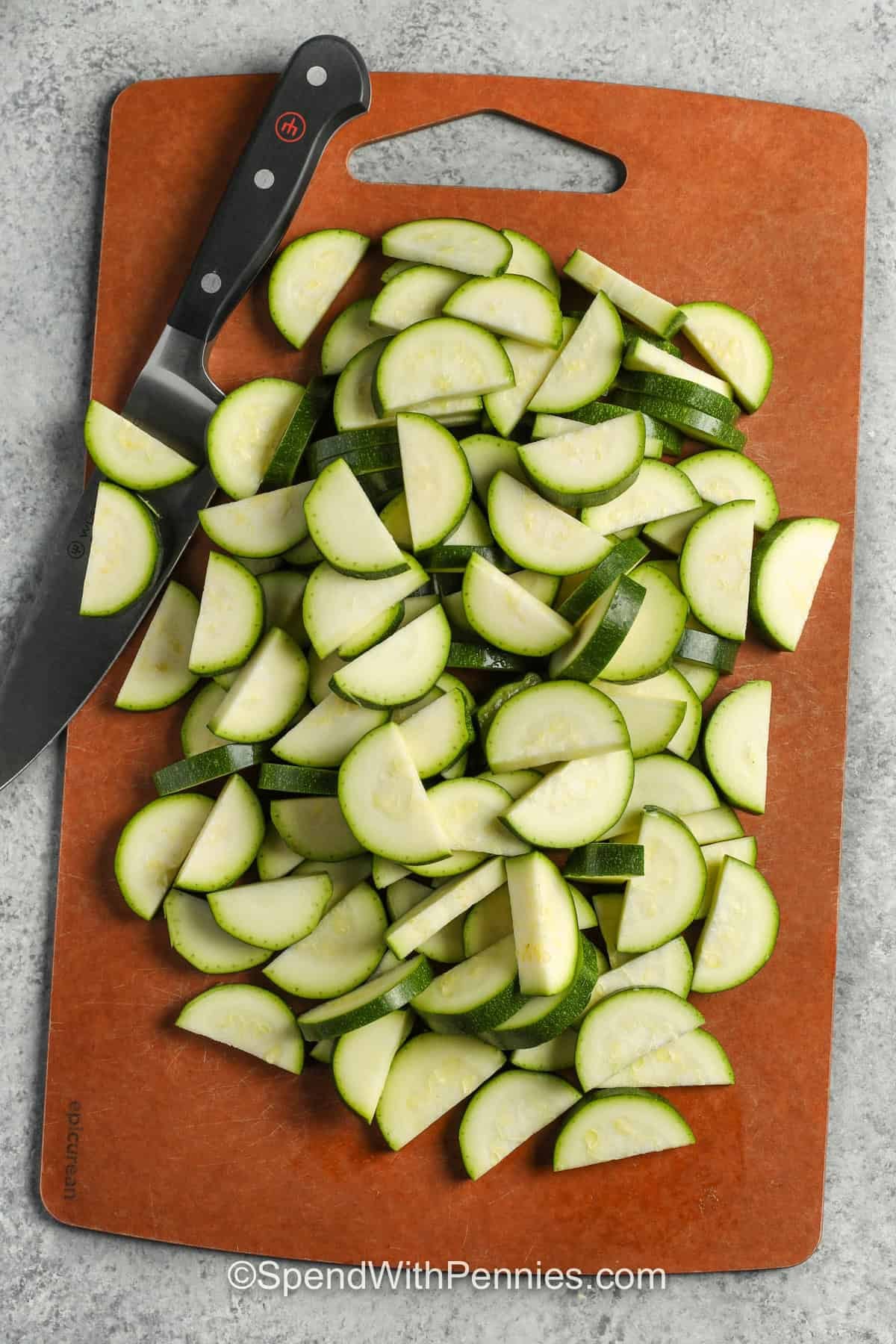 slicing zucchini to make Zucchini Hamburger Casserole