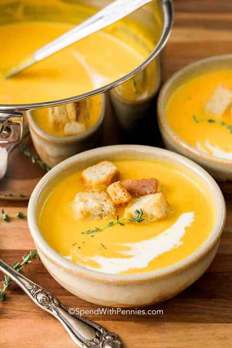 bowls of Butternut Squash Soup with pot full in the back.