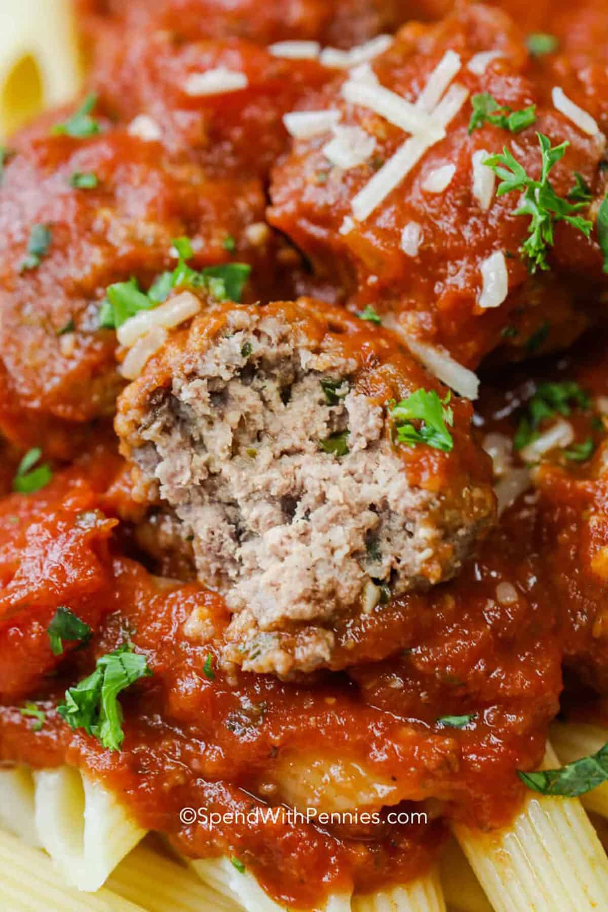 Homemade crockpot meatballs are easier than you might think. Ground beef is mixed with Parmesan, Italian breadcrumbs, parsley, and herbs, then shaped and placed right into the crockpot. Marinara and tomatoes create a rich sauce as everything cooks together, keeping prep simple and the meatballs tender. Serve with spaghetti, garlic bread, or a crisp salad for a cozy dinner. Save these slow cooker meatballs for a busy weeknight. Crockpot Meatballs with a bite taken out of one