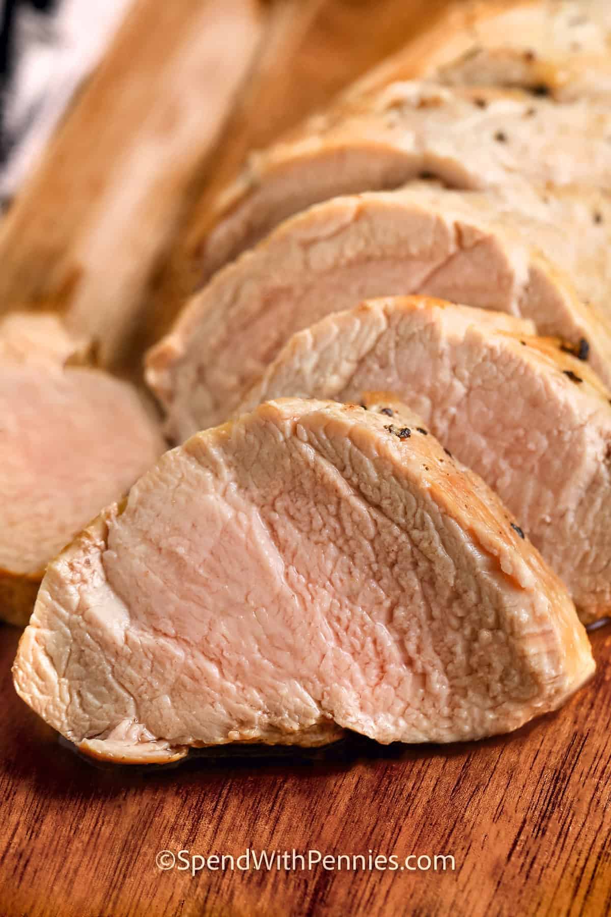 Keep dinner simple with this juicy pork tenderloin recipe and its optional creamy mushroom sauce. The tenderloin is seasoned, browned in olive oil, and oven roasted for an easy main dish with very little hands-on cooking. Use presliced mushrooms and chicken broth to make preparation even faster. Leftover pork is delicious in sandwiches, wraps, salads, and grain bowls. Save this flexible weeknight recipe and make it for dinner soon. #spendwithpennies juicy sliced Pork Tenderloin Recipe