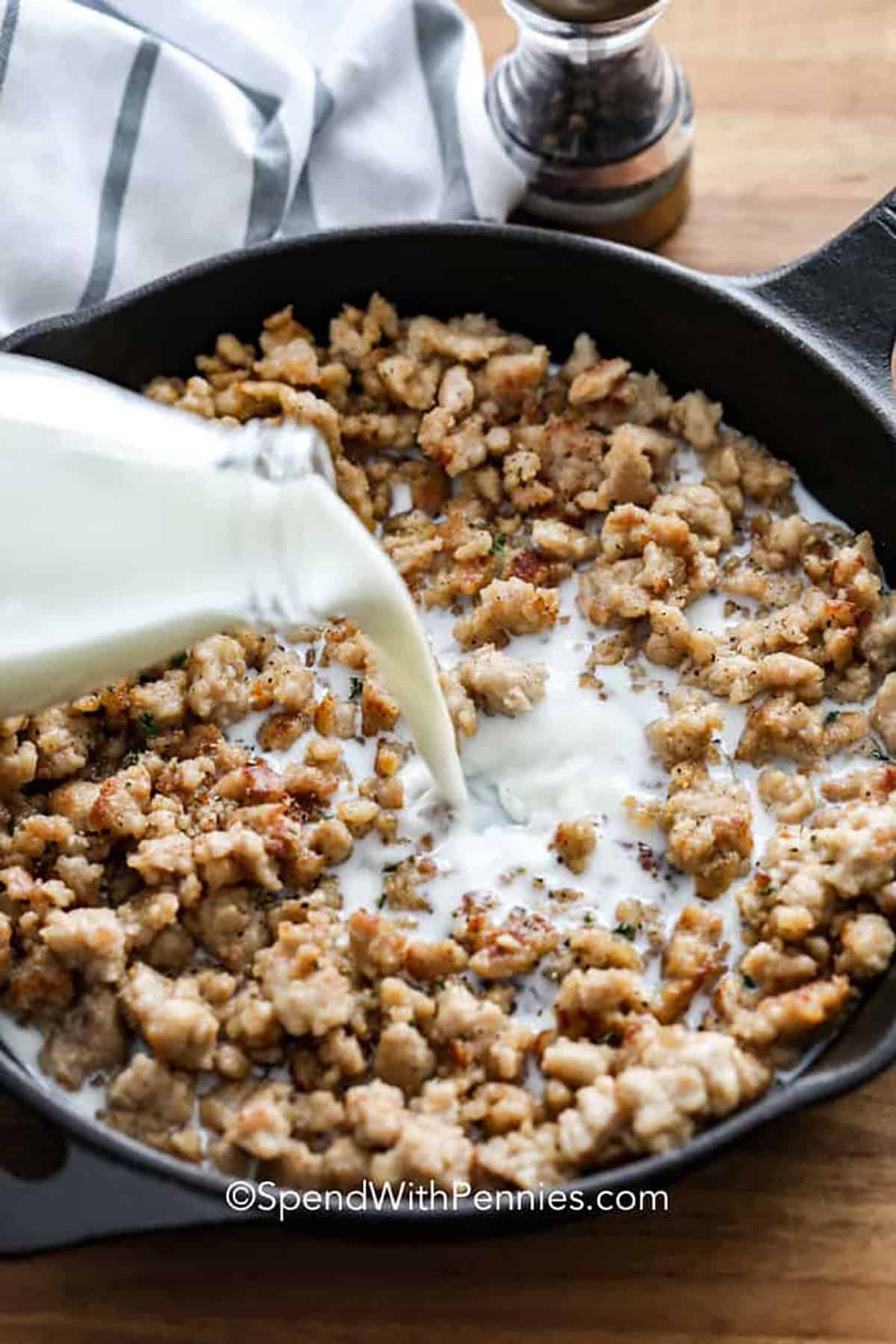 adding half and half to cooked sausage in pan to make Sausage Gravy Recipe