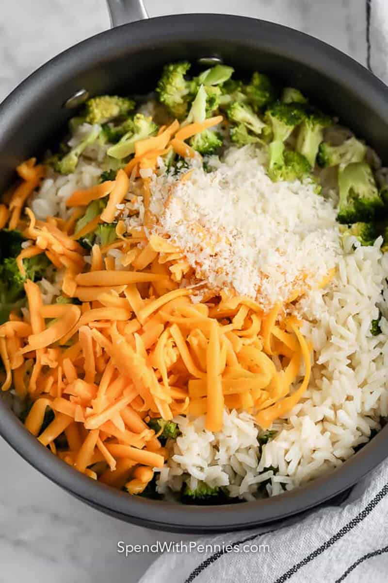 adding cheese to broccoli and rice to make Broccoli Rice