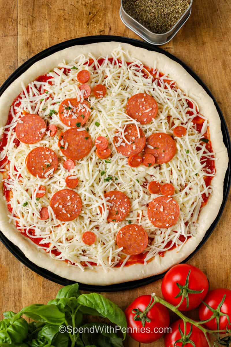 adding toppings to Homemade Pizza Dough