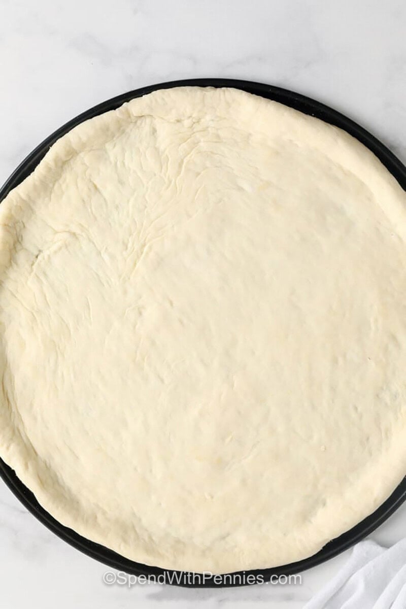 Homemade Pizza Dough on a dish shaped into pizza crust