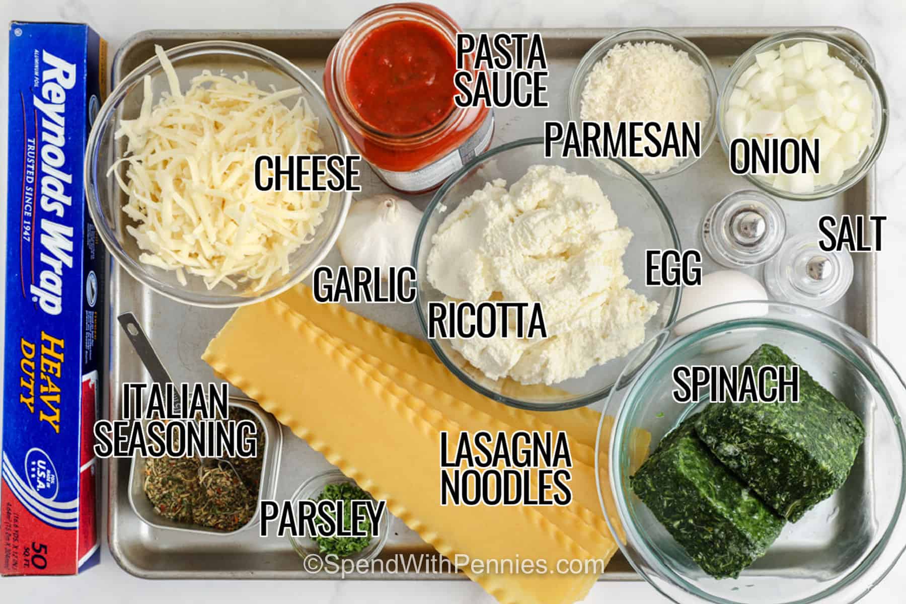 cheese , pasta sauce , parmesan , onion , salt , egg , spinach , ricotta , lasagna noodles garlic , parsley , Italian seasoning with labels to make close up of Spinach Lasagna.