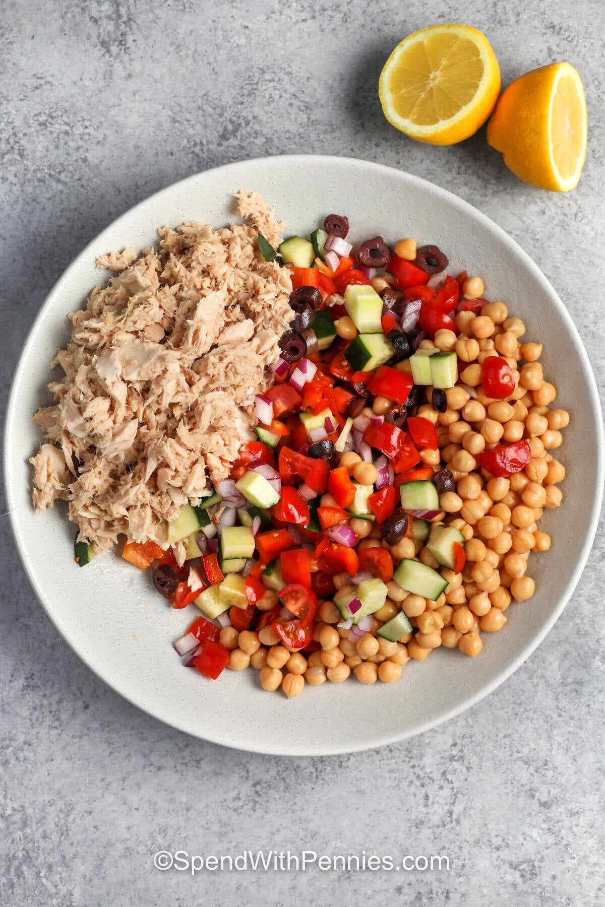 Canned tuna, mixed chopped veggies, and chickpeas in a bowl.