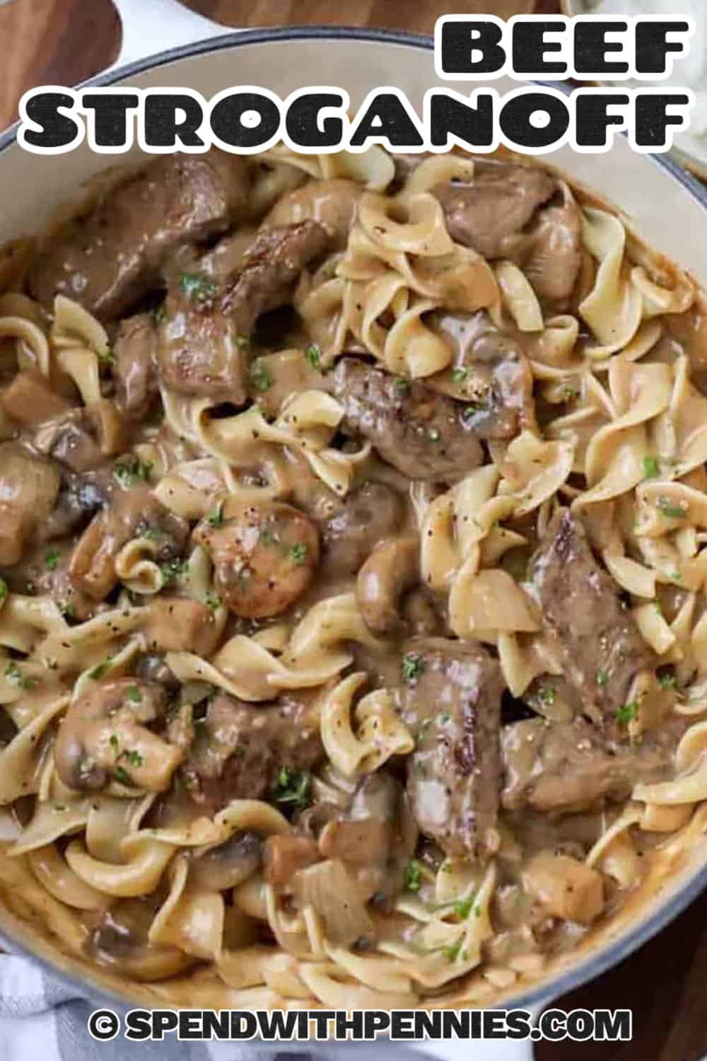 creamy Beef Stroganoff in the pot with writing