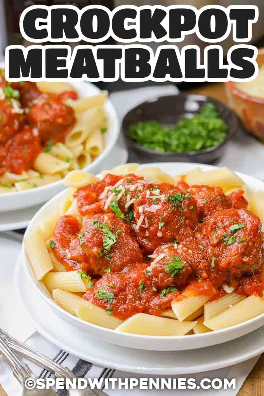 Tender homemade crockpot meatballs simmer in tomato sauce while the slow cooker handles almost all of the work. Ground beef, Italian breadcrumbs, Parmesan, parsley, and seasoning give every meatball plenty of savory flavor, while jarred marinara keeps prep quick. Serve the meatballs and sauce over spaghetti or turn leftovers into cheesy subs the next day. Save this meatballs recipe for an easy, cozy dinner. #spendwithpennies plated Crockpot Meatballs on pasta with writing.