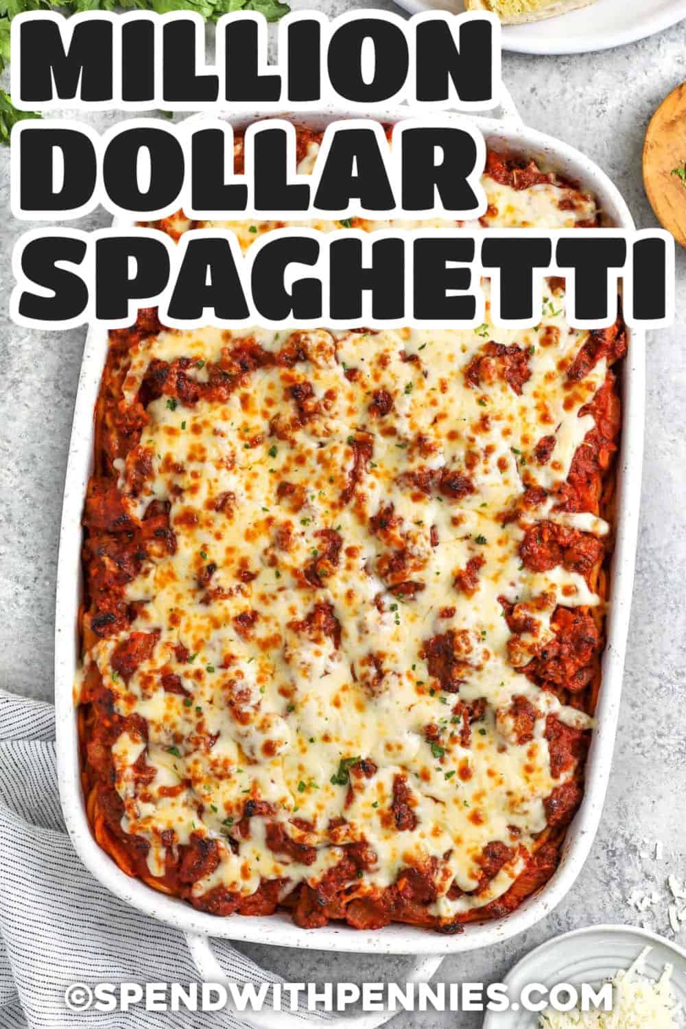 This million dollar spaghetti recipe combines the comfort of spaghetti with the creamy, cheesy layers of a baked pasta casserole. Italian sausage adds savory flavor, marinara keeps every forkful saucy, and cream cheese, cottage cheese, sour cream, and mozzarella create a rich center. It can also be assembled ahead for easier dinner prep. Add this make-ahead casserole to your dinner board and save it for later. #spendwithpennies casserole dish of Million Dollar Spaghetti with a title