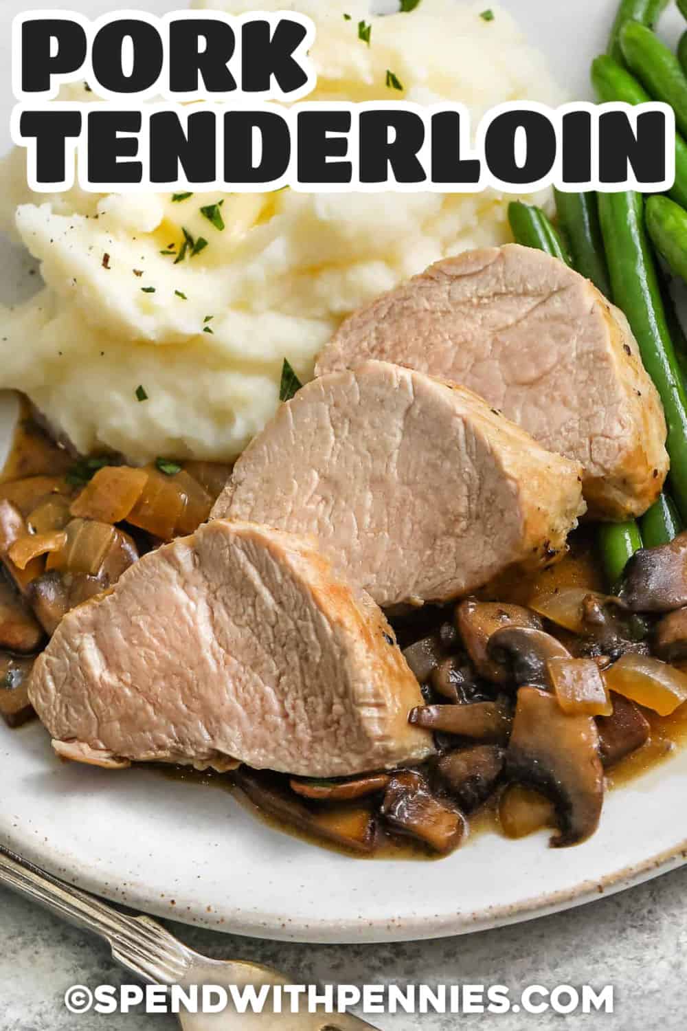 Make this easy pork tenderloin recipe when you need a comforting dinner that cooks in about 25 minutes. Searing the pork in a skillet creates plenty of savory flavor, while an instant-read thermometer helps keep the center moist and tender. The creamy mushroom pan sauce is optional and can be made with white wine or chicken broth. Serve it with mashed potatoes, rice, or roasted vegetables. Pin this dependable pork recipe for later. #spendwithpennies plated Pork Tenderloin Recipe with gravy , mashed potatoes and green beans with a title