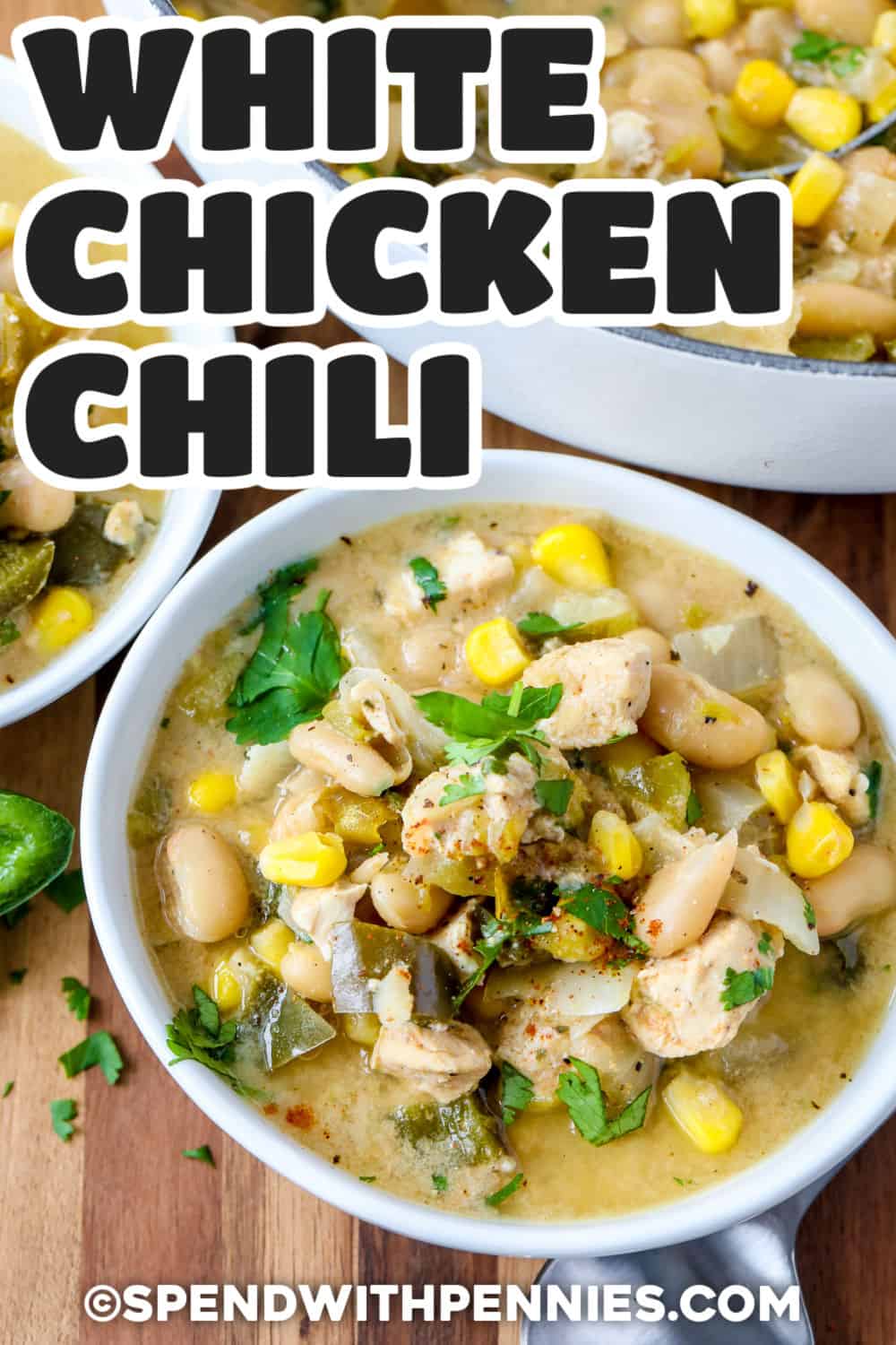 Easy white chicken chili turns simple chicken, white beans, corn, and green chiles into a creamy, comforting meal in about 45 minutes. Everything simmers together on the stovetop, so there are fewer dishes to wash and plenty of flavor in every spoonful. Poblanos add mild earthy flavor, and sour cream makes the finished broth rich and smooth. Keep this recipe handy for chilly evenings and busy weeknights. Pin it for dinner tonight. #spendwithpennies White Chicken Chili in bowls with a title.