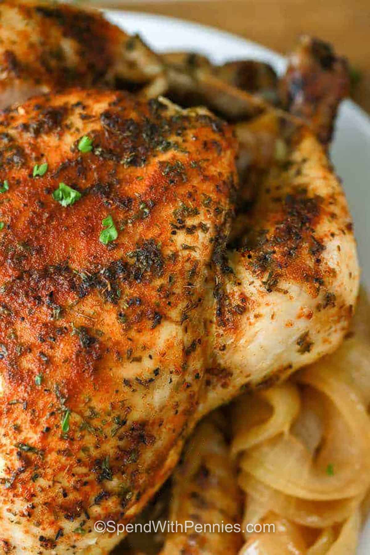 Slow cooker whole chicken and gravy is an easy way to put a comforting Sunday-style meal on the table without spending all afternoon in the kitchen. A whole chicken is coated with olive oil, smoked paprika, thyme, garlic, and seasoned salt before cooking until juicy and tender. The flavorful drippings are thickened into a smooth gravy that is perfect with mashed potatoes or vegetables. Save this recipe for an easy family dinner. #spendwithpennies close up of juicy Slow Cooker Whole Chicken & Gravy