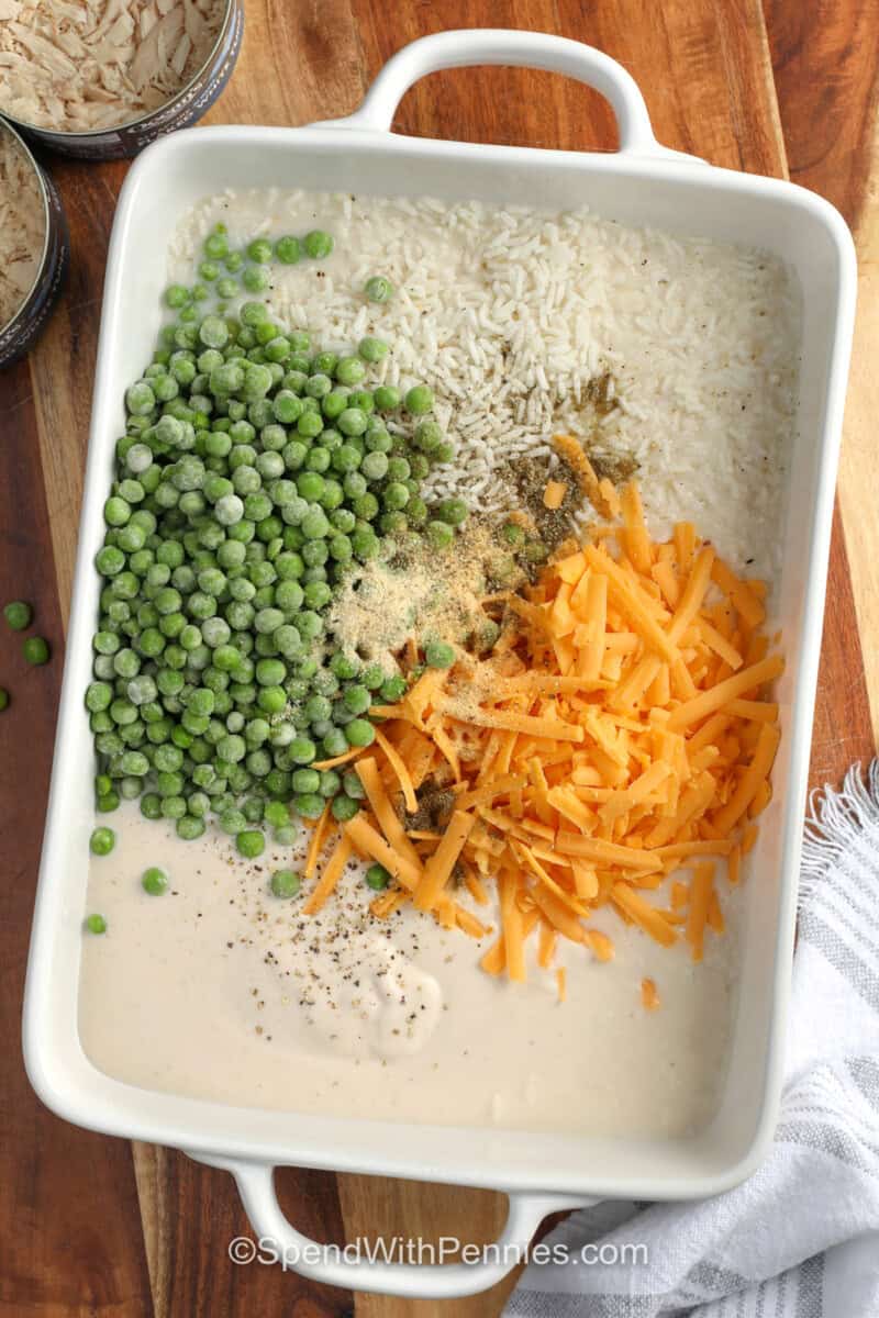 adding ingredients to dish to make Tuna Rice Casserole