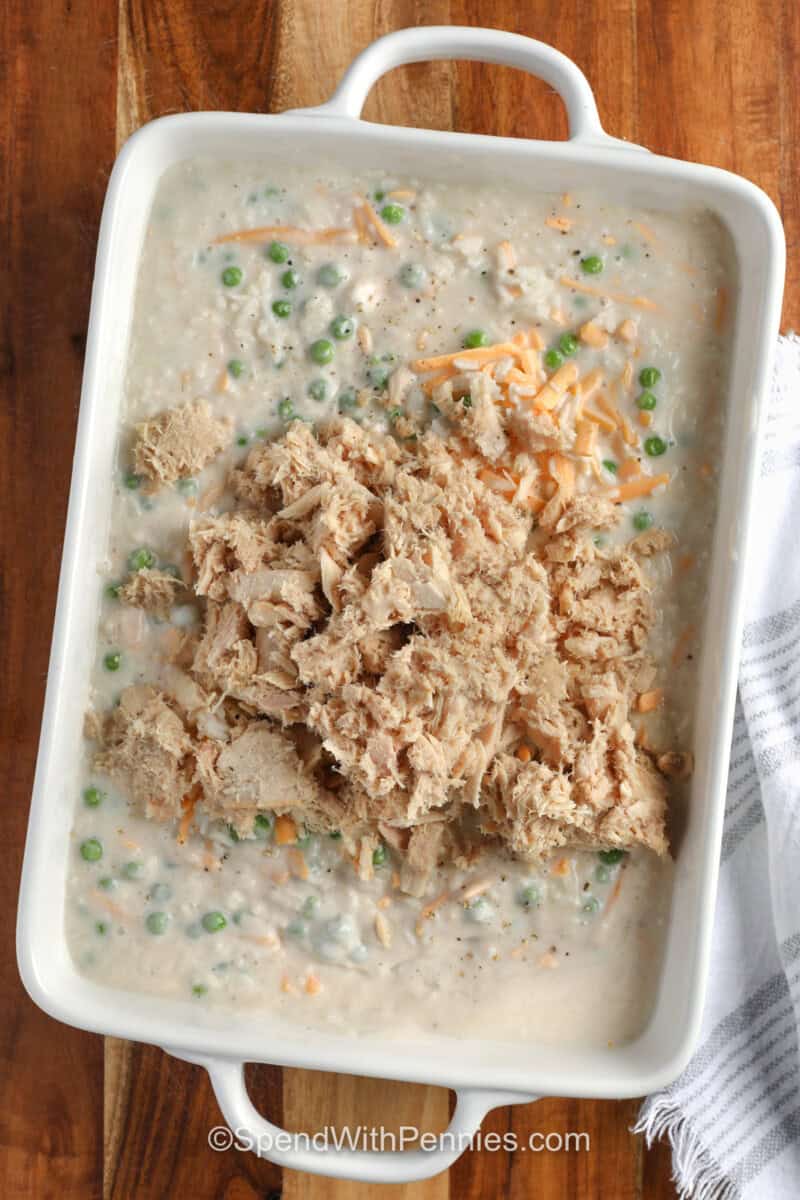 adding tuna to ingredients to make Tuna Rice Casserole