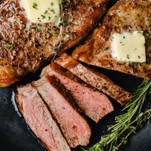 close up of cooked steak in a pan to show how to cook Steak in the Oven.