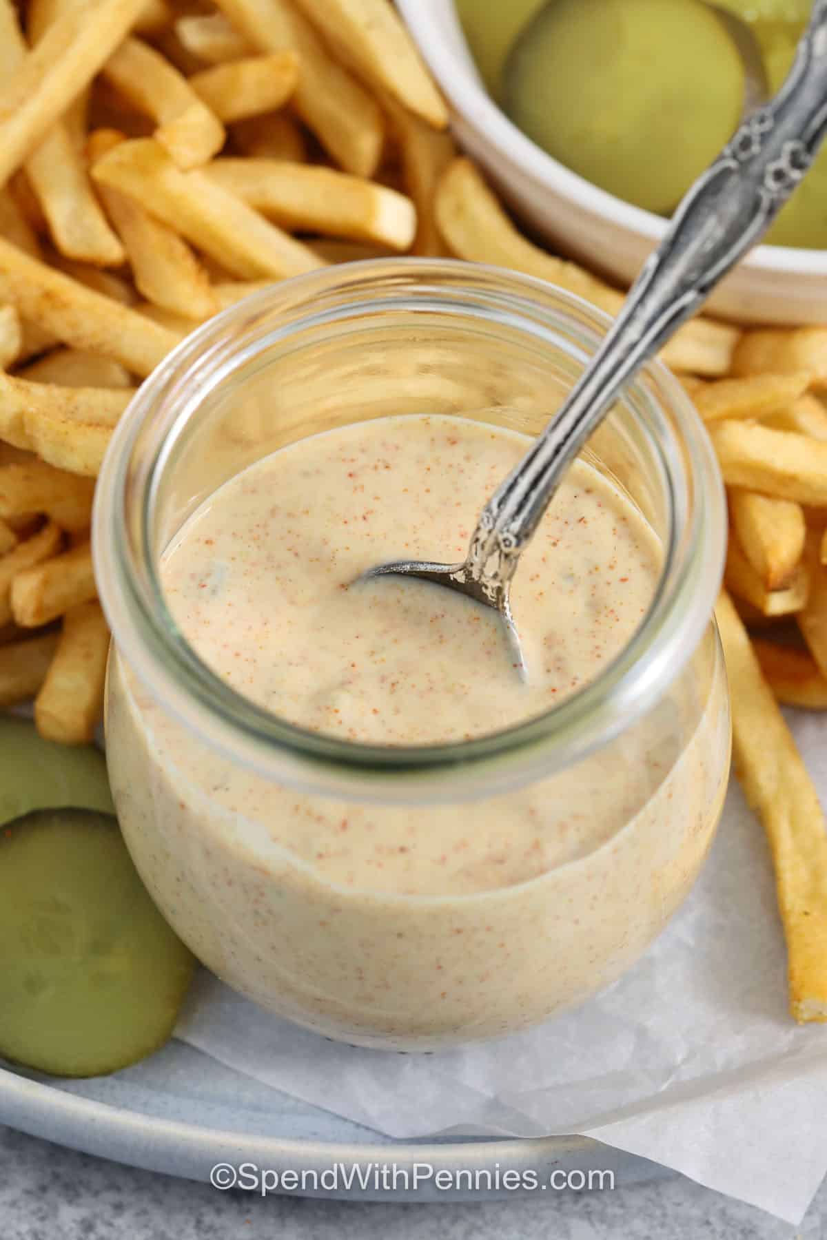 Make Big Mac Sauce at home when you want an easy condiment that works for more than burgers. Creamy mayonnaise is mixed with sweet pickle relish, mustard, vinegar, paprika, onion powder, and garlic powder for a rich sauce with plenty of tang. Use it for dipping hot fries, spreading on sandwiches, or drizzling over burger bowls and salads. Save this easy sauce recipe for your next cookout or weeknight dinner. #spendwithpennies jar of Big Mac Sauce and a spoon.