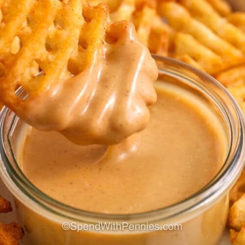 dipping waffle fries in Chick-Fil-A Sauce.