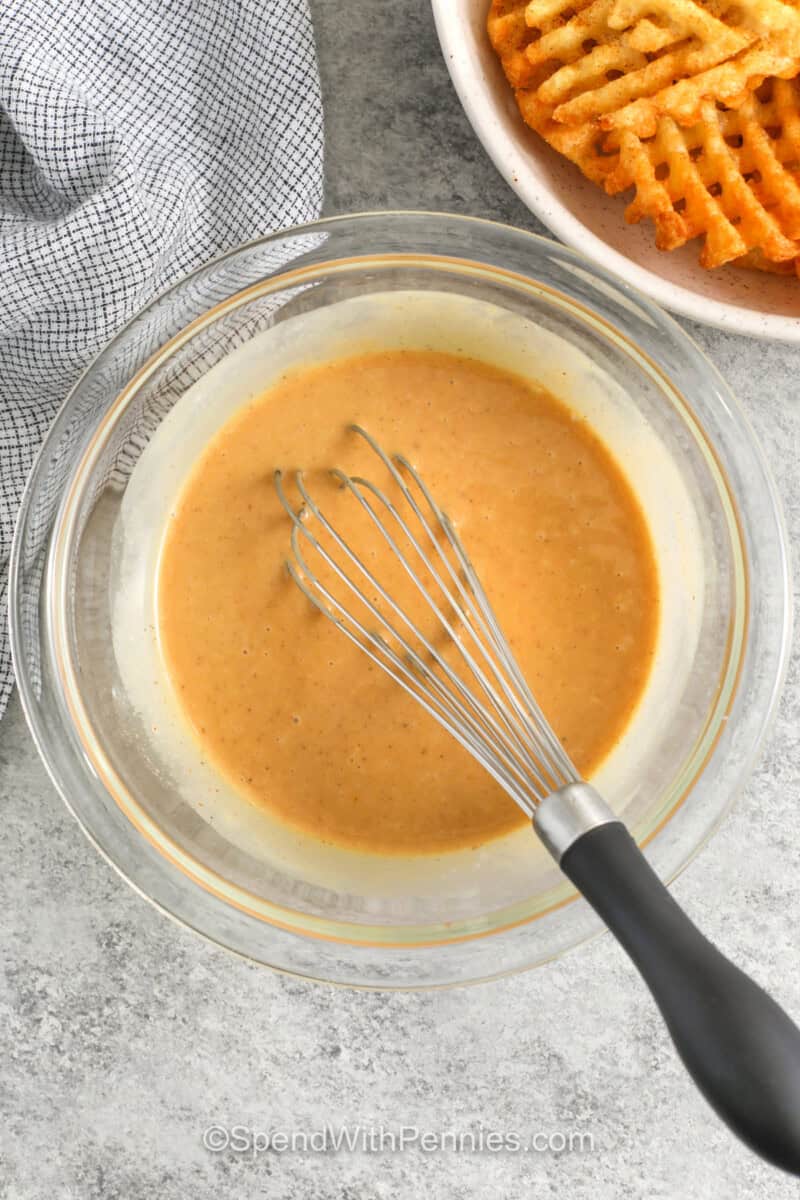 whisking ingredients together to make Chick-Fil-A Sauce.