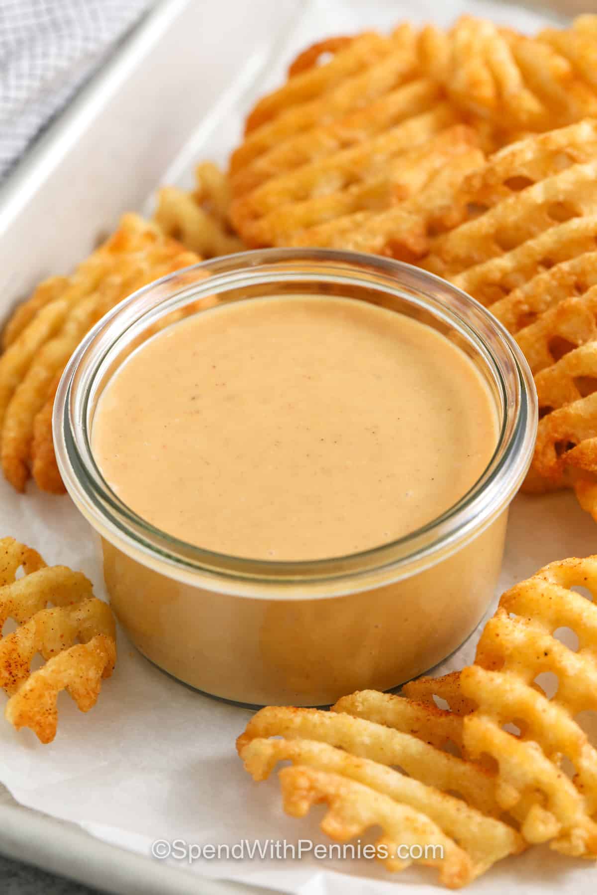 sheet pan with a dish of Chick-Fil-A Sauce with fries around it.