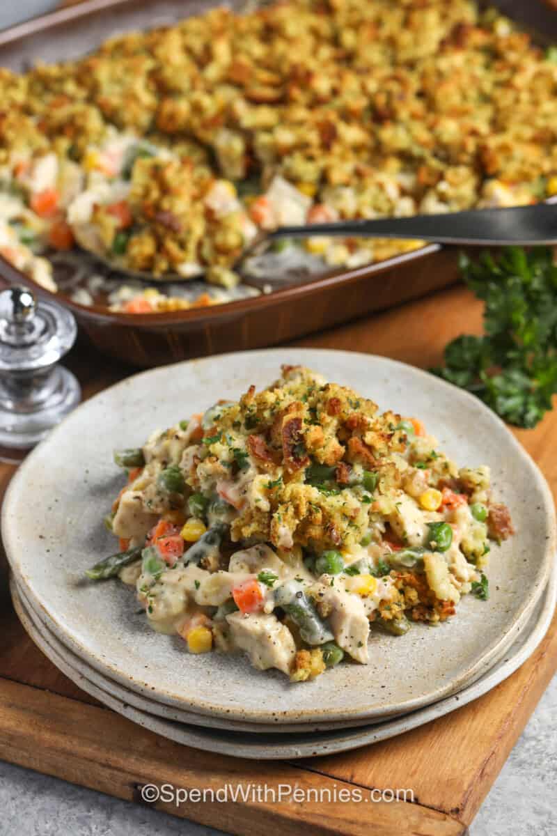 Chicken Stuffing Casserole on a plate with casserole dish full in the back.