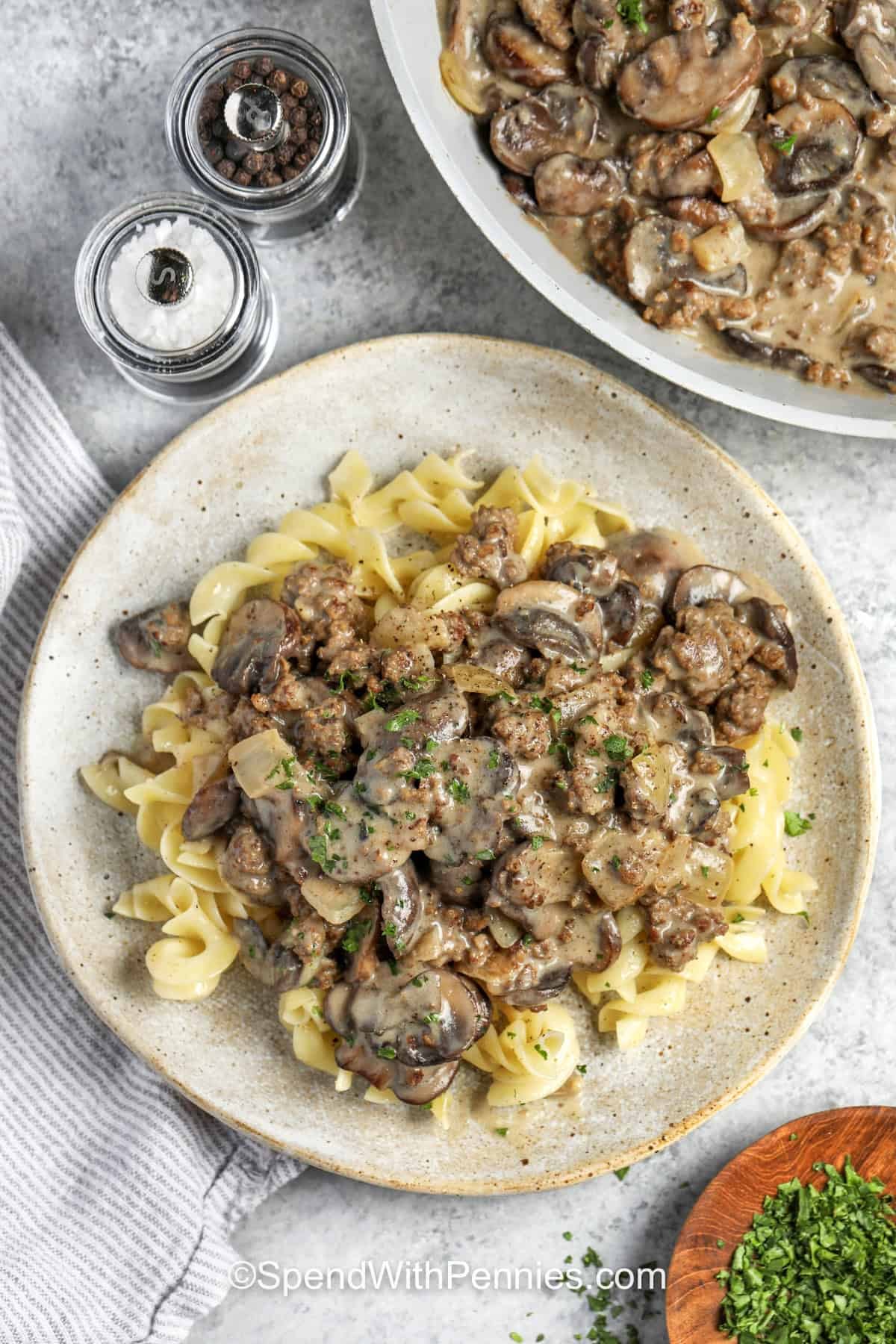 Ground Beef Stroganoff on noodles with pan full in the back.