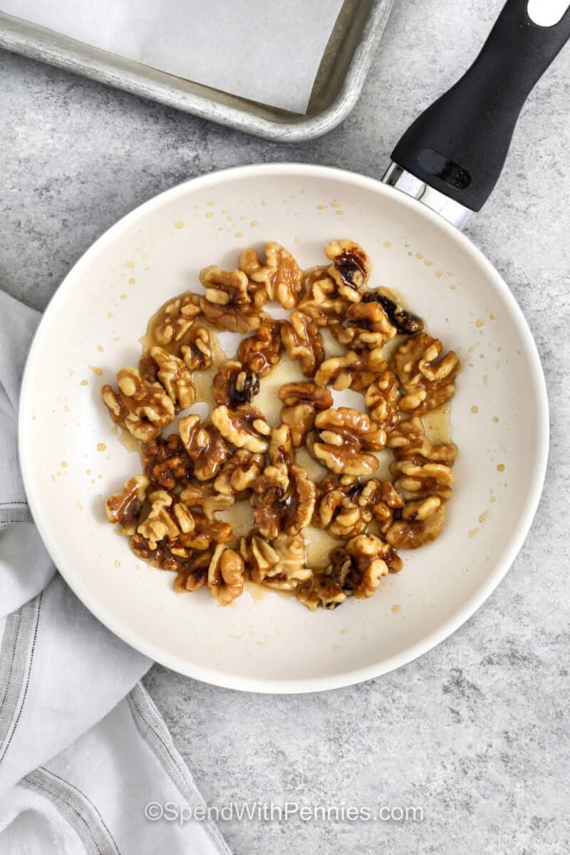 walnuts cooking in pan to make Honey Walnut Shrimp.