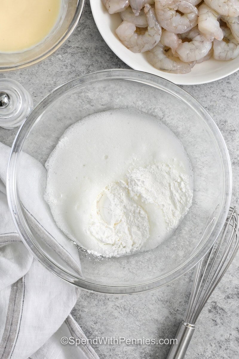 adding egg whites to dry ingredients to make Honey Walnut Shrimp.