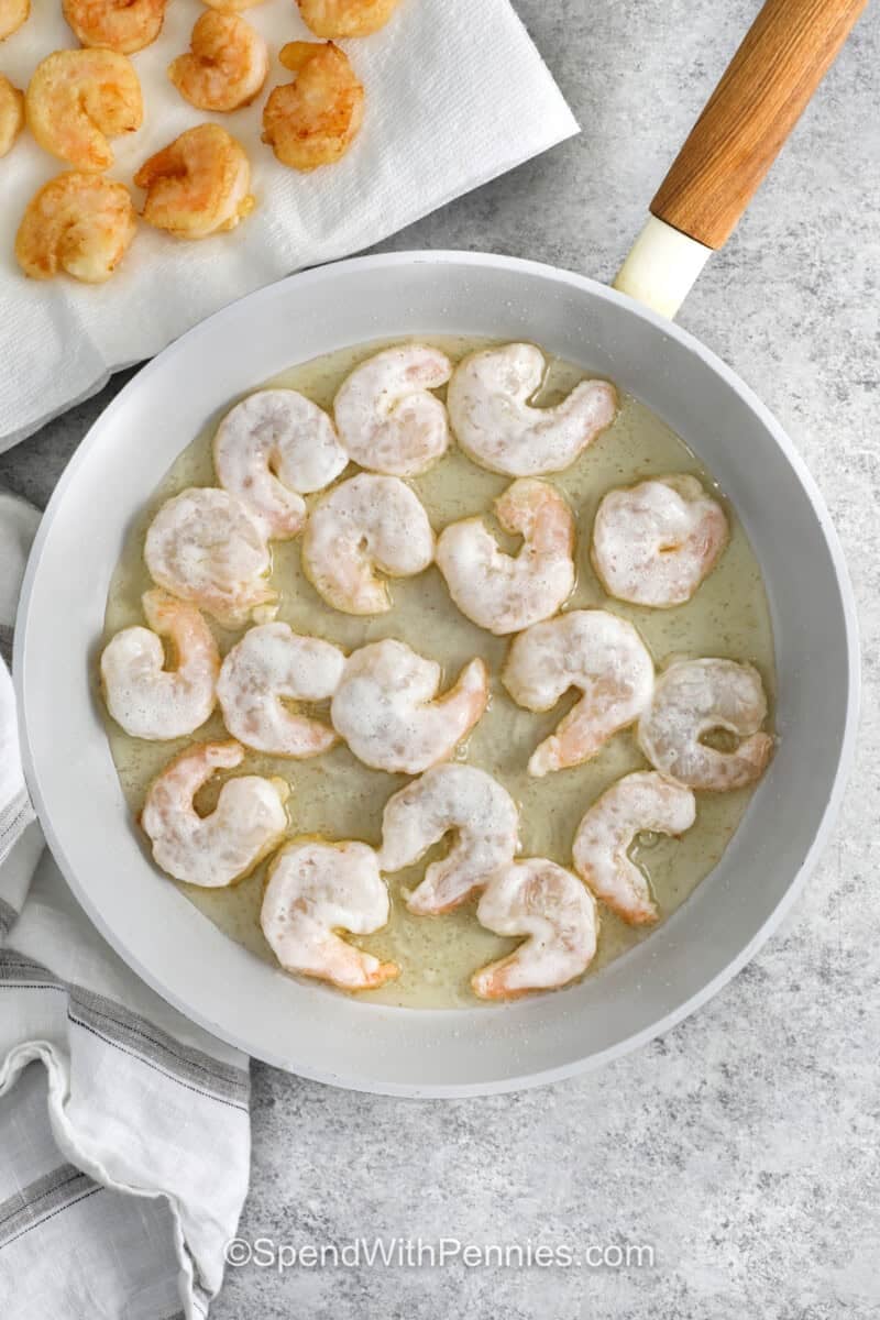 shrimp cooking in a pan to make Honey Walnut Shrimp.