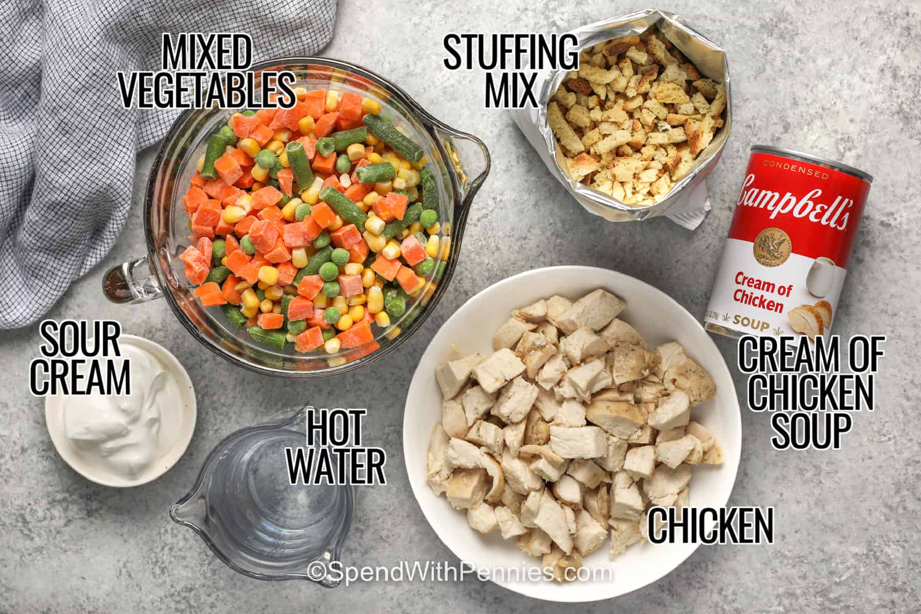 Chicken stuffing casserole is an easy comfort food dinner with tender cooked chicken, colorful mixed vegetables, and a creamy sauce under a savory golden stuffing topping. Rotisserie chicken and frozen vegetables make prep especially fast, so this cozy casserole is practical enough for a busy weeknight. It is hearty, family-friendly, and ready in about 35 minutes. Save this easy chicken stuffing casserole for your next cozy dinner. #spendwithpennies cream of chicken soup , chicken , stuffing mix , hot water , mixed vegetables and sour cream with titles to show how to make Chicken Stuffing Casserole.