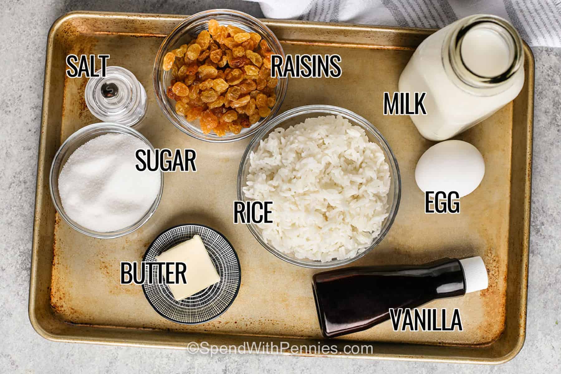 Easy rice pudding is a delicious way to give leftover cooked rice a second life. White rice simmers gently with whole milk and sugar, then egg, butter, vanilla, cinnamon, and nutmeg turn it into a thick and creamy homemade dessert. Golden raisins add sweet little bites but can easily be left out. This stovetop recipe is simple enough for a weeknight and cozy enough for Sunday dinner. Save this creamy rice pudding recipe to try soon. #spendwithpennies salt , raisins , sugar , butter , rice , milk , egg , vanilla with labels to make Homemade Rice Pudding.