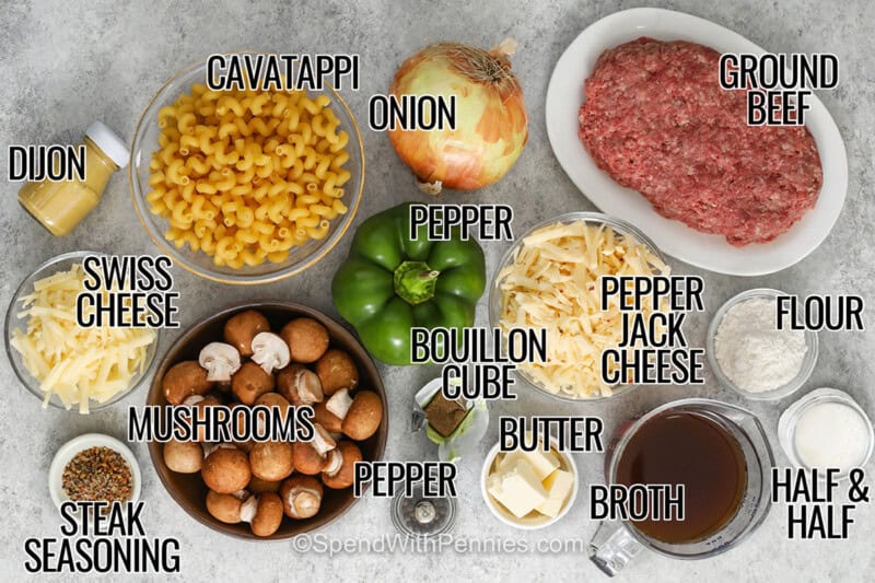 dijon mustard , Swiss cheese , steak seasoning , mushrooms , pepper , bouillon cube , pepper , onion , cavatappi pasta , ground beef , pepper jack cheese , butter , broth , flour , half and half with labels to make Philly Cheesesteak Casserole.