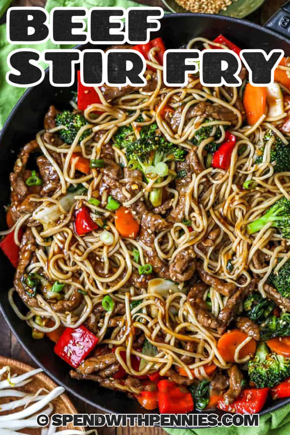 Make beef stir fry at home with tender sirloin steak, broccoli, bell peppers, and a savory-sweet ginger soy sauce. The steak is sliced thinly across the grain and quickly seared in a hot skillet, while the vegetables cook just until crisp and colorful. This flexible dinner is perfect for using the vegetables already in the fridge and tastes delicious over rice or noodles. Save this easy beef stir fry for a busy weeknight meal. #spendwithpennies pan of Beef Stir Fry with a title.