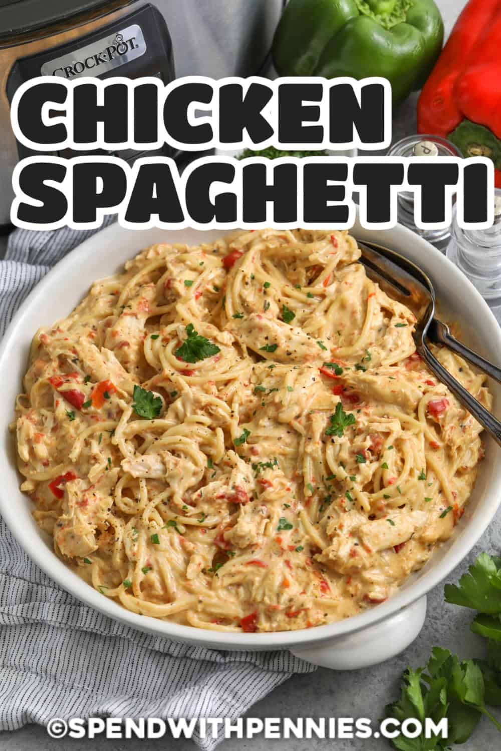 Cheesy Crockpot chicken spaghetti makes a hearty family dinner with tender chicken breasts, Rotel tomatoes, bell pepper, cheddar cheese, Parmesan, and spaghetti. The slow cooker builds the savory base while the pasta cooks separately, so the noodles stay tender instead of becoming overly soft. Every serving is creamy, cheesy, and packed with comforting flavor. Pin this slow cooker chicken spaghetti for your next cozy weeknight meal. #spendwithpennies bowl of Crockpot Chicken Spaghetti with a title.