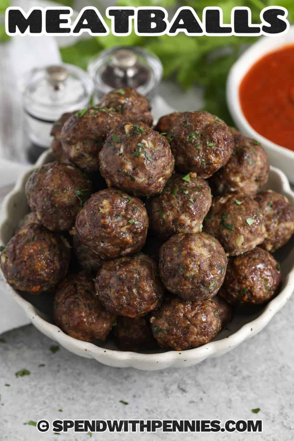 These easy homemade meatball recipe are flavorful, tender, and ready in about 40 minutes from start to finish. The meatball recipe uses ground beef, ground pork, breadcrumbs, milk, Parmesan cheese, egg, and simple seasonings for a classic taste that pairs with so many meals. Bake them all at once, serve with sauce if desired, and save leftovers for quick lunches or freezer dinners. #spendwithpennies Easy Meatball Recipe in a bowl with a title