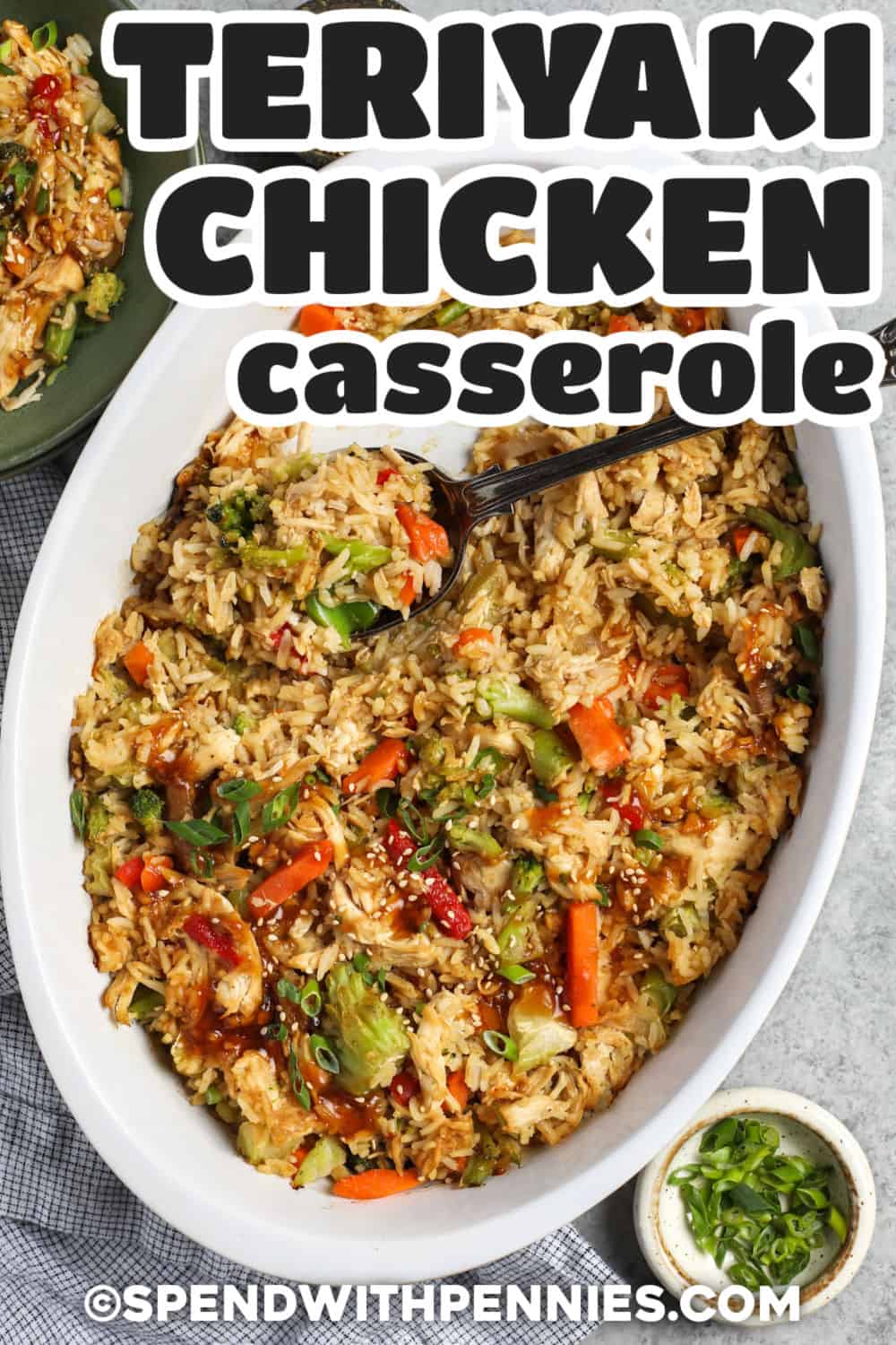 This teriyaki chicken casserole rice bake gives leftover chicken and cooked rice a fresh new flavor with a homemade sweet and savory sauce. Frozen stir-fry vegetables go right into the baking dish, while soy sauce, fresh ginger, garlic, brown sugar, and orange or pineapple juice create plenty of teriyaki flavor. It is colorful, comforting, and easy to portion for lunches the next day. Pin this recipe for your next leftover chicken dinner. #spendwithpennies Teriyaki Chicken Casserole in the casserole dish with a title.