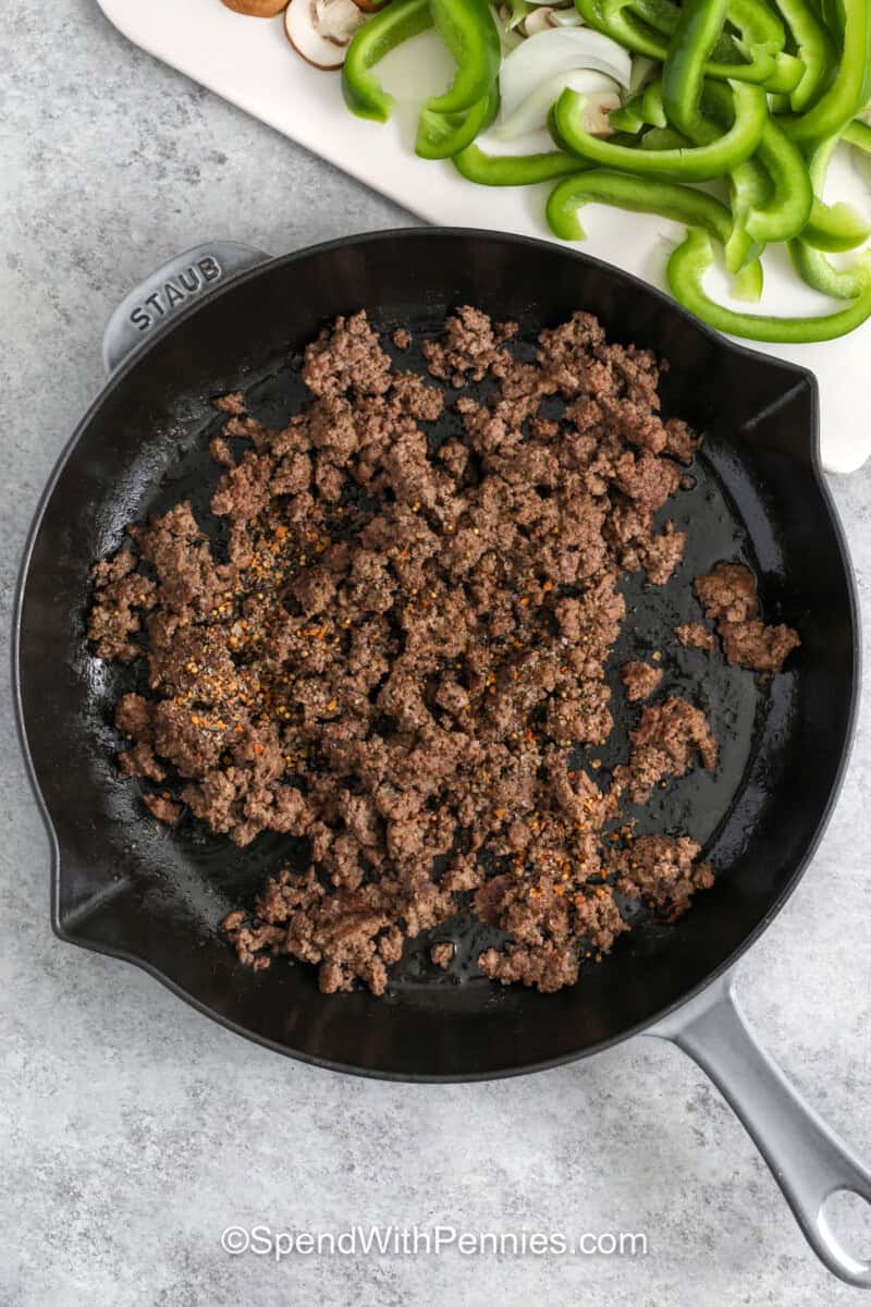 cooking beef in a pan to make Philly Cheesesteak Casserole.