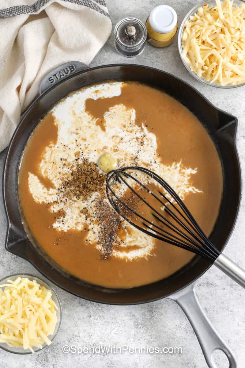whisking ingredients together to make sauce for Philly Cheesesteak Casserole.