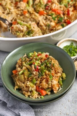 plated Teriyaki Chicken Casserole with pan full in the back.