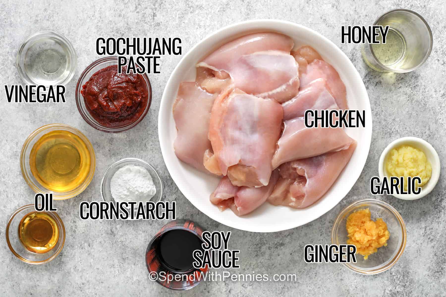 This gochujang chicken recipe combines tender chicken thighs with a sticky sauce made from gochujang, honey, soy sauce, garlic, fresh ginger, and sesame oil. The chicken is browned in a skillet first, giving every bite extra flavor before it is tossed in the glossy sweet and spicy sauce. Serve it over fluffy rice with green onions for an easy dinner that feels special without extra work. Save this recipe for your next weeknight dinner. #spendiwithpennies chicken , vinegar , oil , gochujang paste , cornstarch , soy sauce , ginger , garlic , honey with labels to make Gochujang Chicken.
