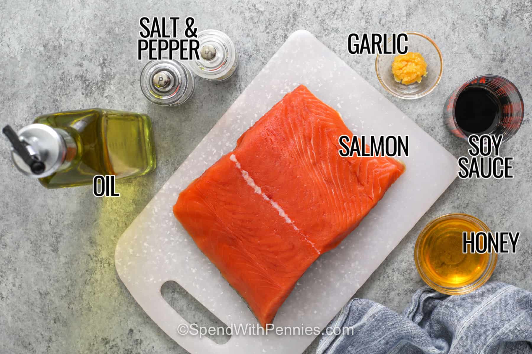 Easy salmon bites make weeknight seafood feel simple with a short ingredient list and fast cooking time. The salmon is cut into bite-sized pieces and flavored with honey, soy sauce, and garlic before being pan seared until golden. Serve these tender salmon cubes over warm rice, add them to a fresh salad, or pair them with vegetables and spicy mayo. Pin this honey garlic salmon bites recipe for a quick and versatile dinner. #spendwithpennies Labelled ingredients for Salmon bites.