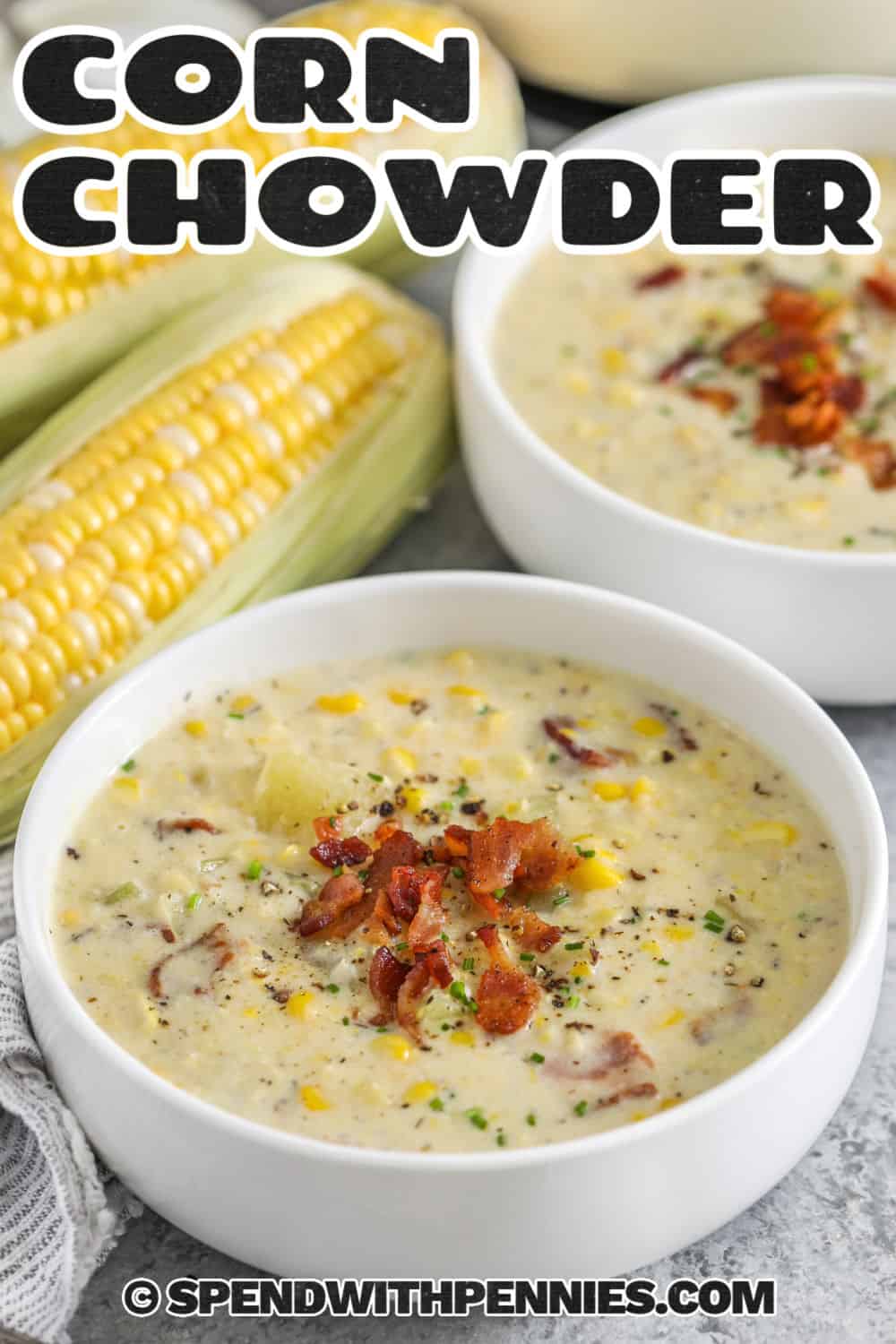 This creamy corn chowder recipe with bacon is an easy stovetop soup made with potatoes, sweet corn, celery, milk, and cream. The potatoes become perfectly tender while the corn adds little bursts of sweetness to every bowl. Blending just a portion gives the broth a thick, velvety texture while keeping plenty of corn and potatoes intact. Save this easy corn chowder recipe for dinner. #spendwithpennies bowls of Corn Chowder Recipe with a title.